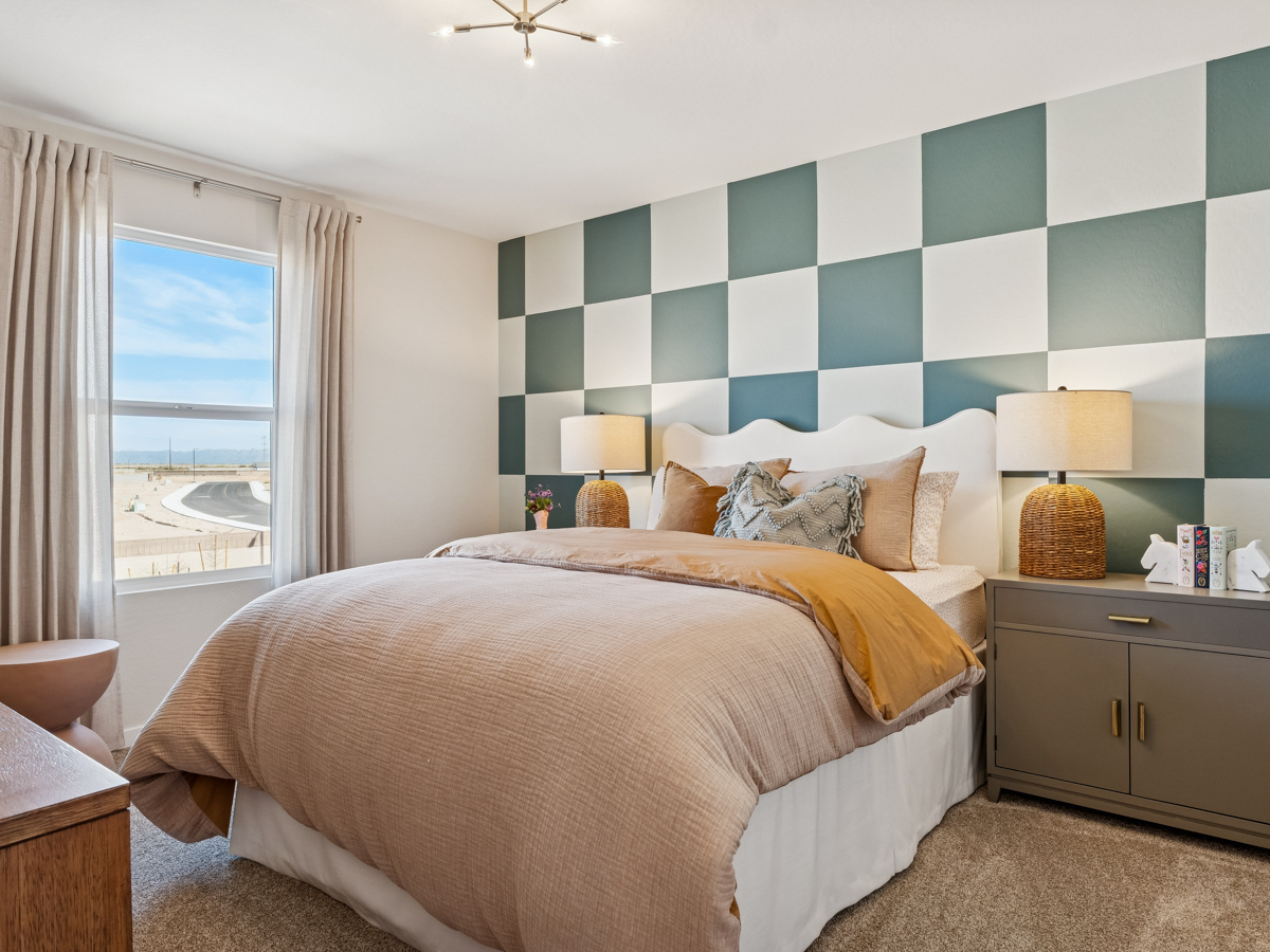 A bedroom with a large window.