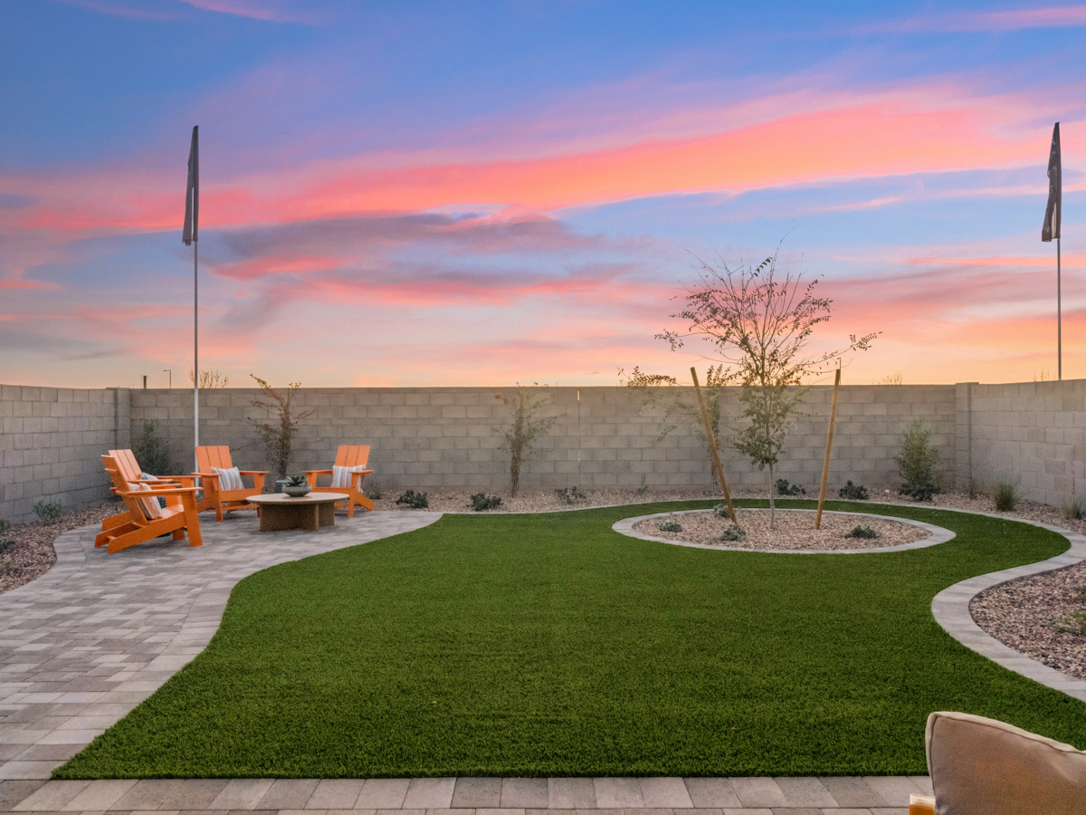 A park with benches and a tree.