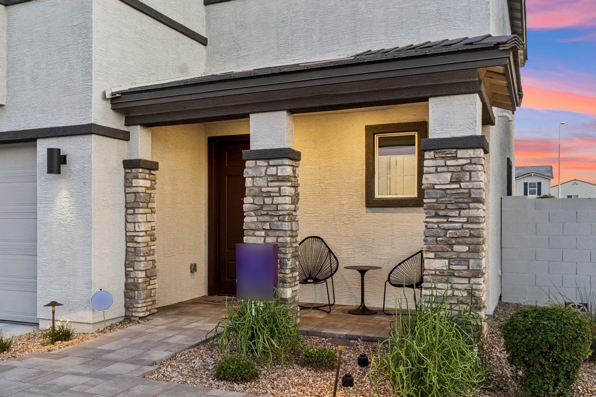 A house with a patio and chairs.