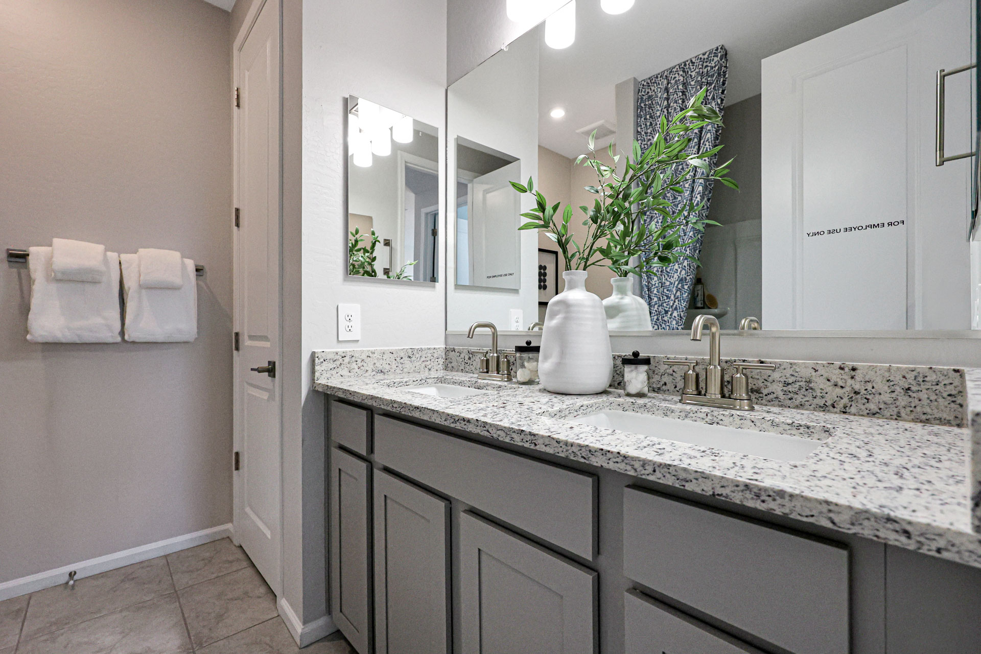 A bathroom with a large mirror.