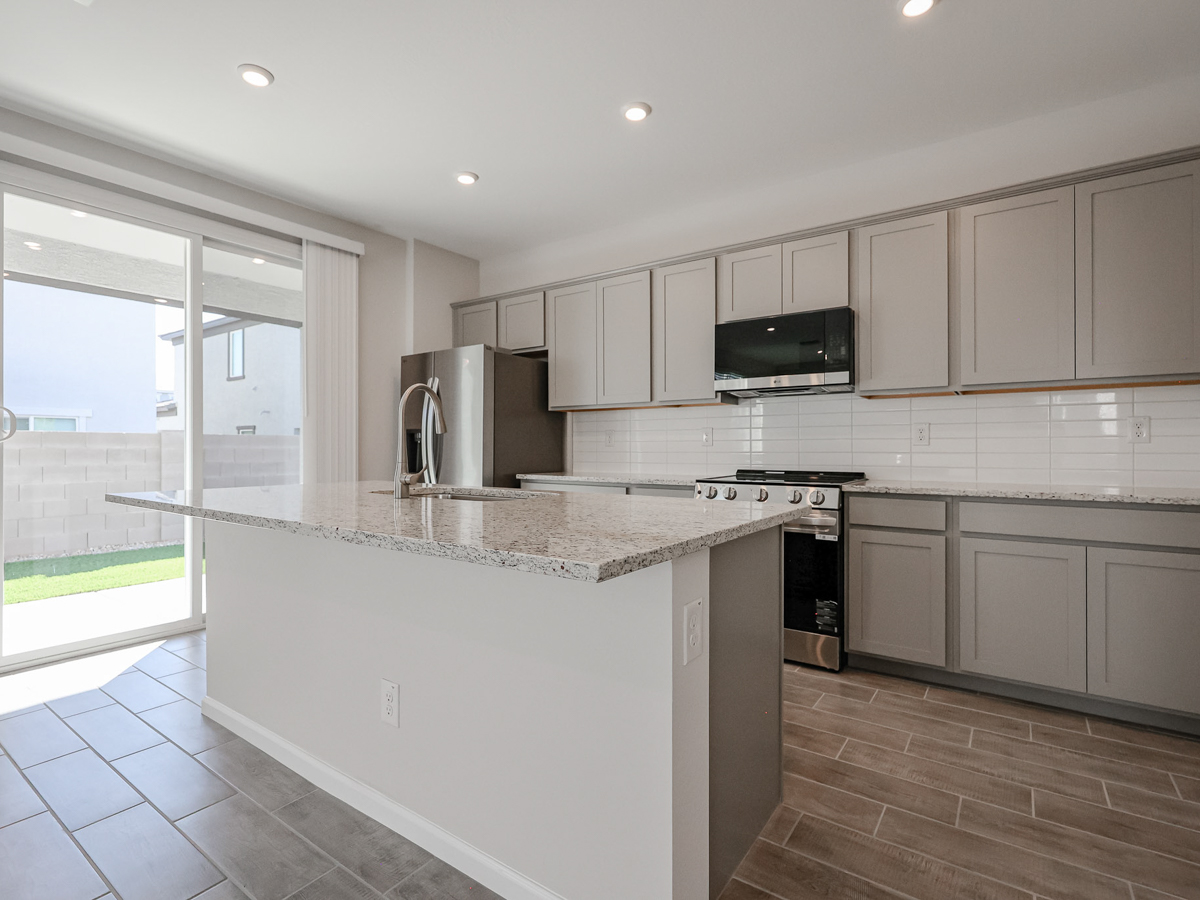 A kitchen with white cabinets.