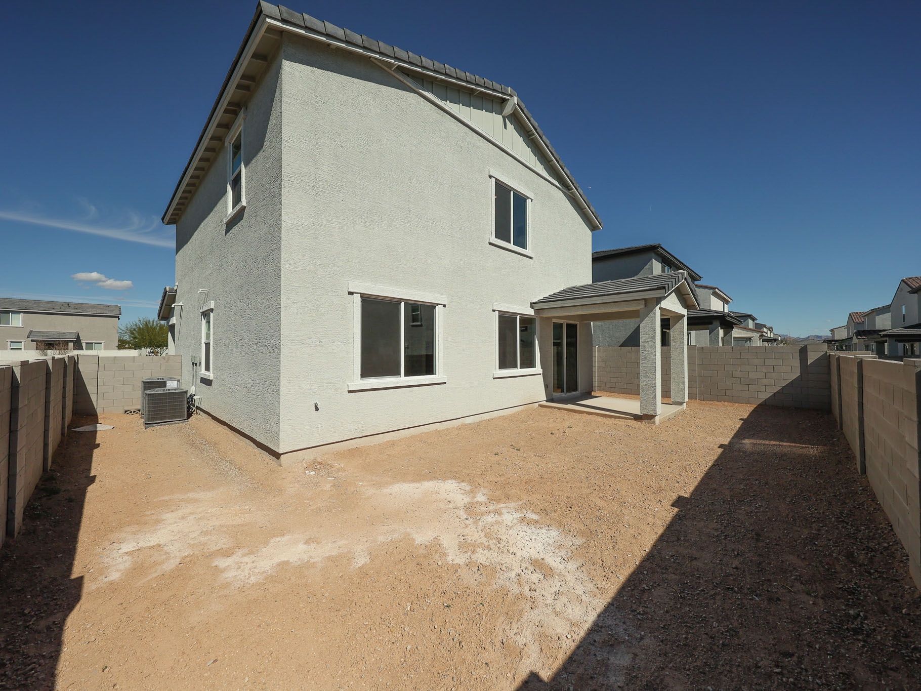 A white house with a dirt road.