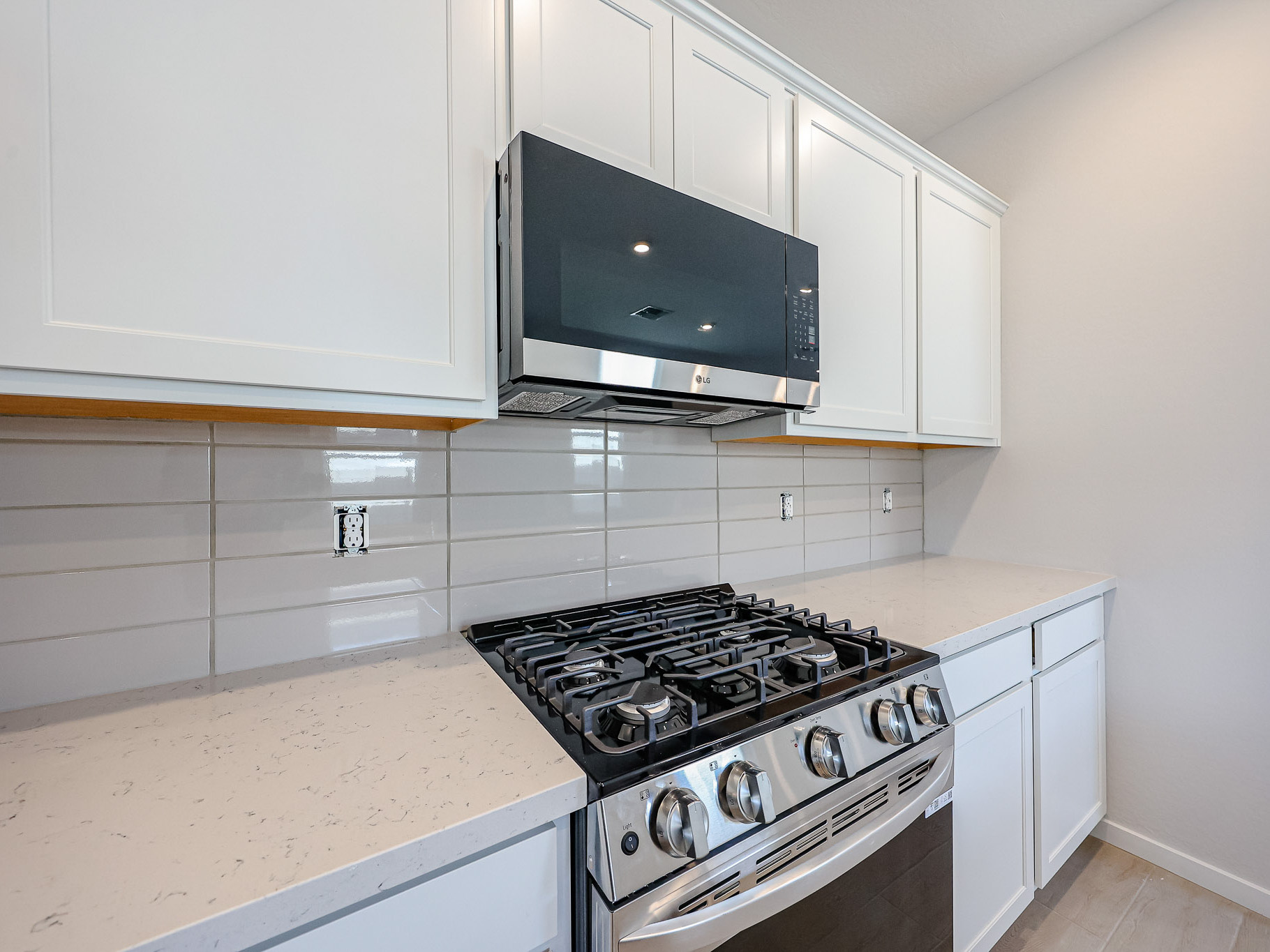 A kitchen with white cabinets.