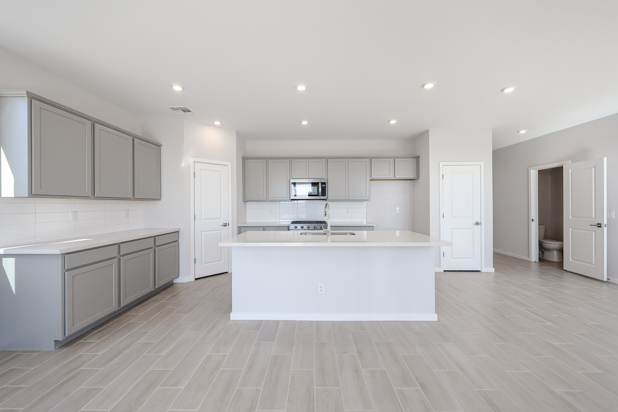 A large kitchen with white cabinets.