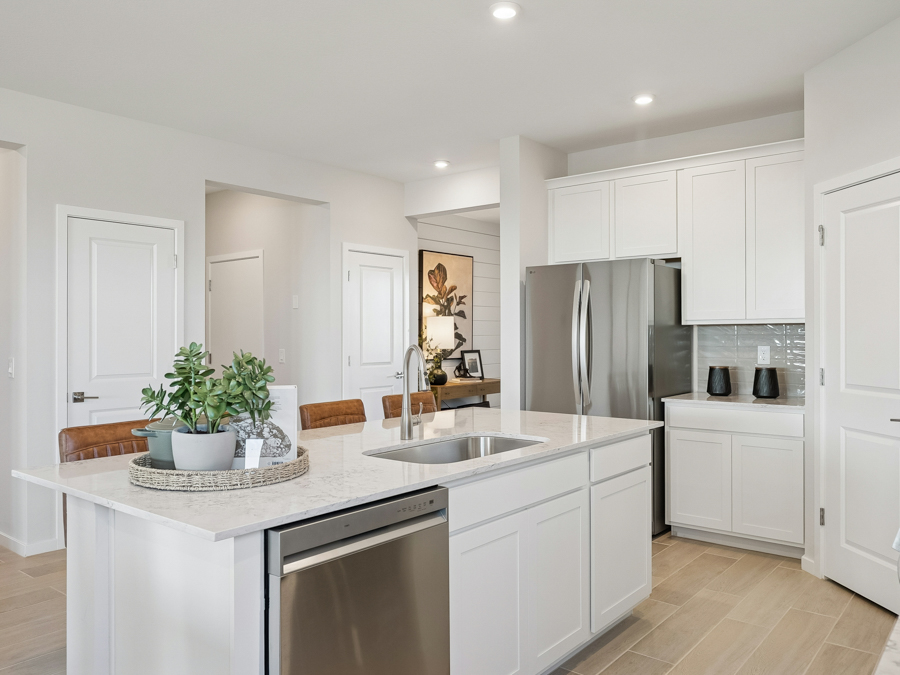 A kitchen with white cabinets.