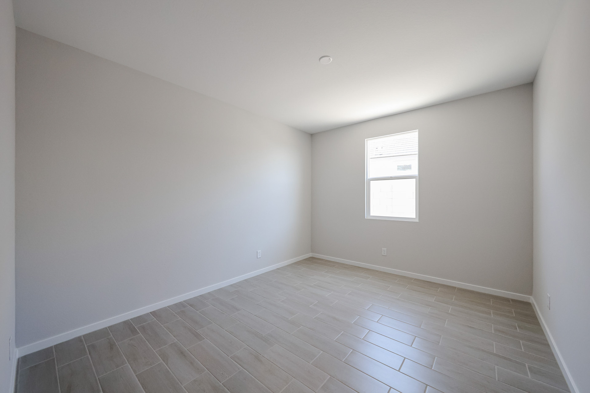 A room with a tile floor and windows.