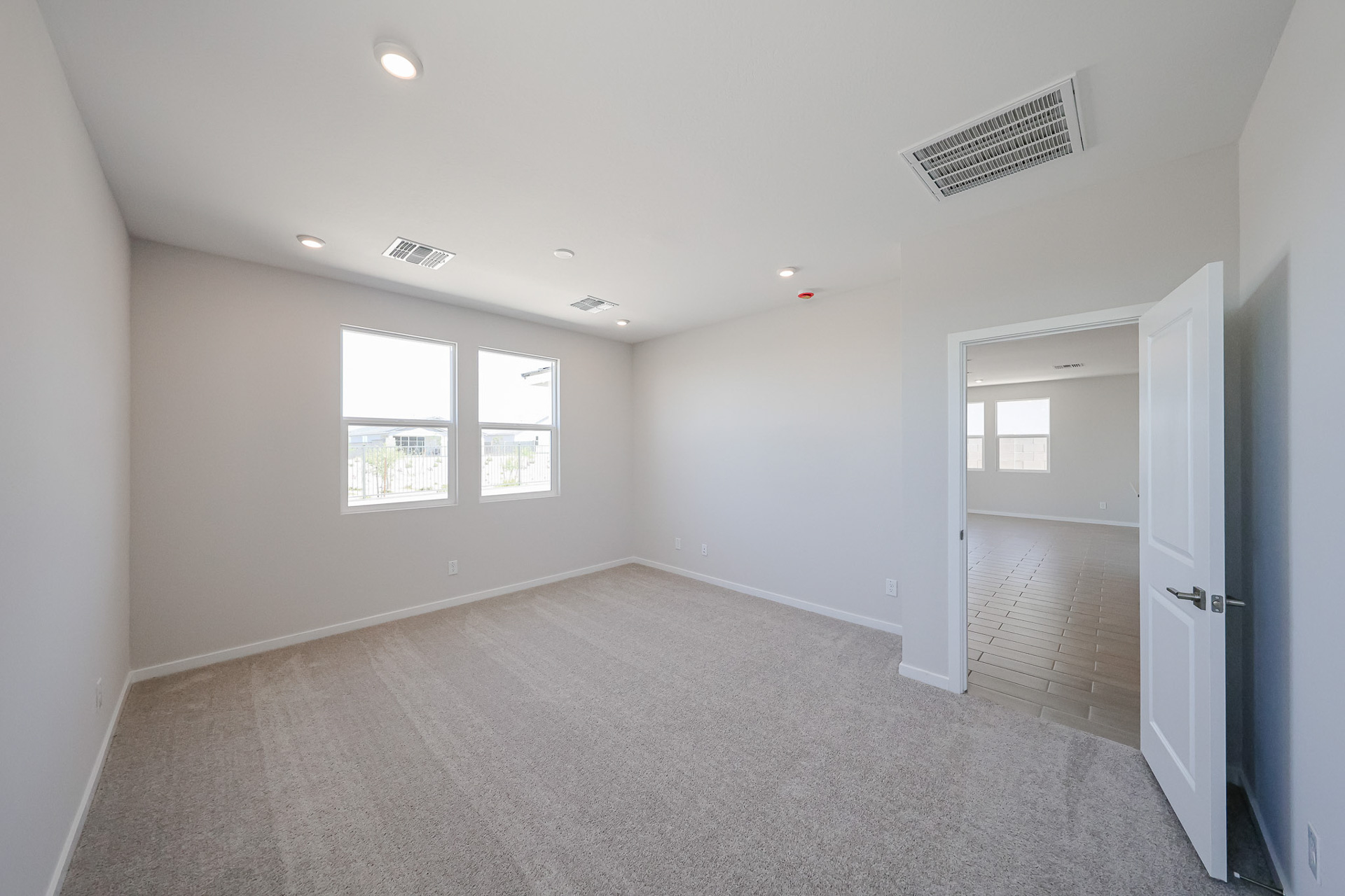 A room with a door and windows.