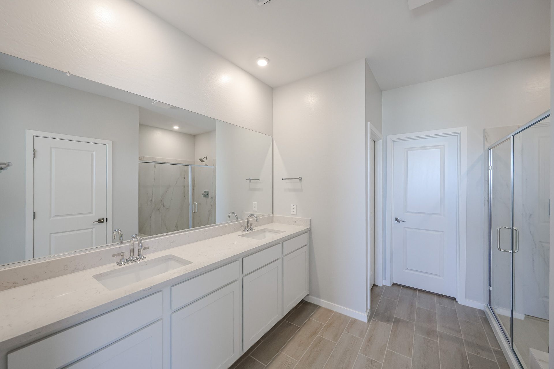 A bathroom with white cabinets.