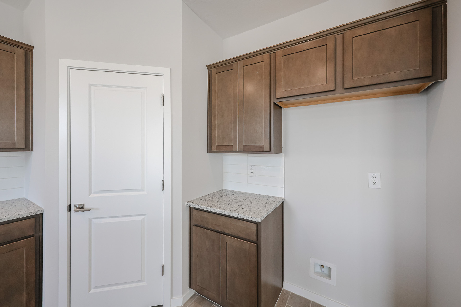 A kitchen with wooden cabinets.