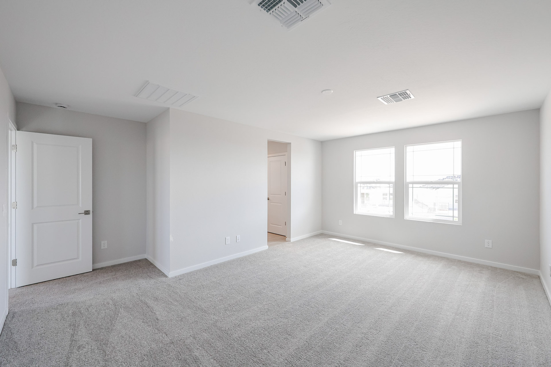 A room with white walls and a carpeted floor.