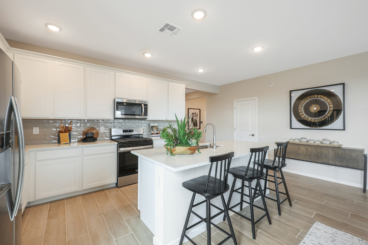 A kitchen with white cabinets.