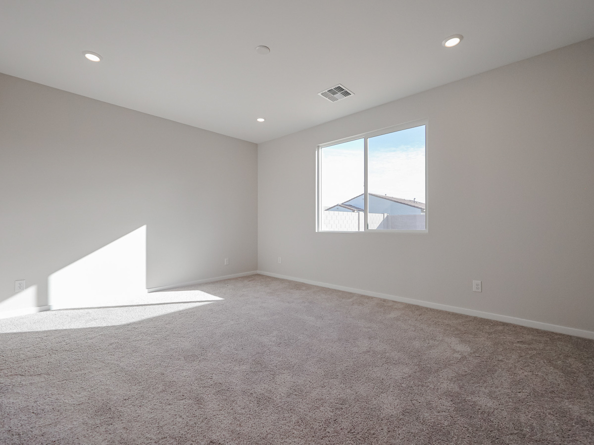 A room with a window and carpet.