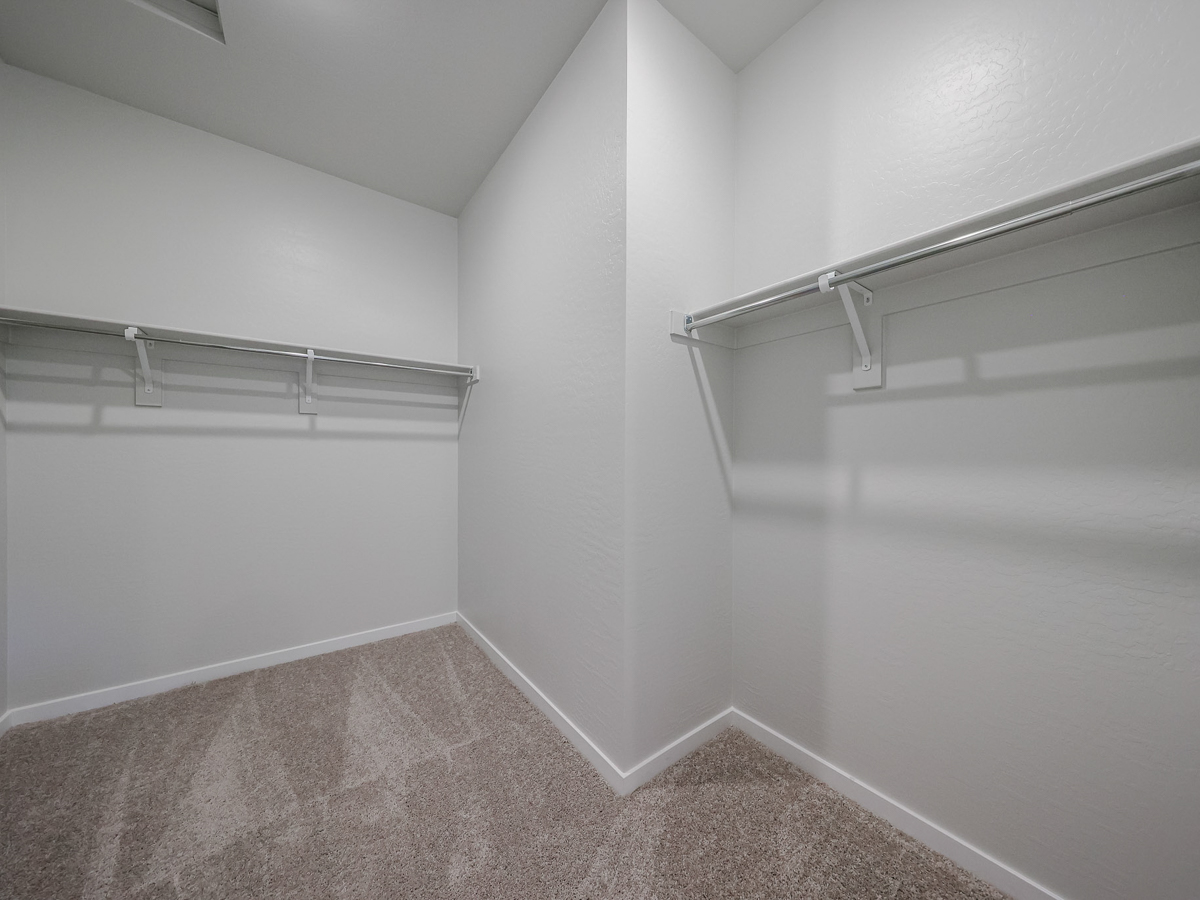 A white wall with a metal railing.