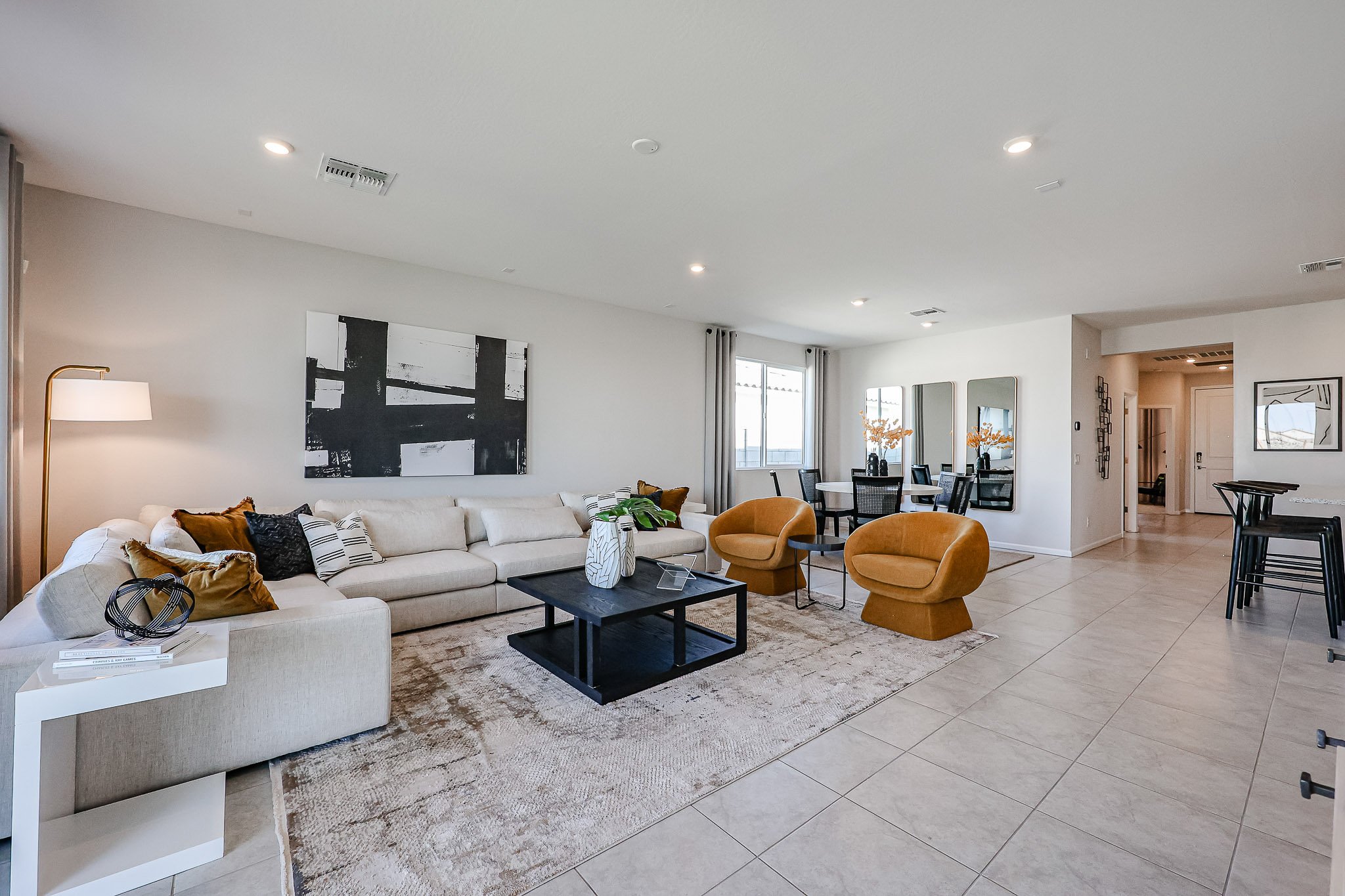 A living room with a large white couch and a coffee table.