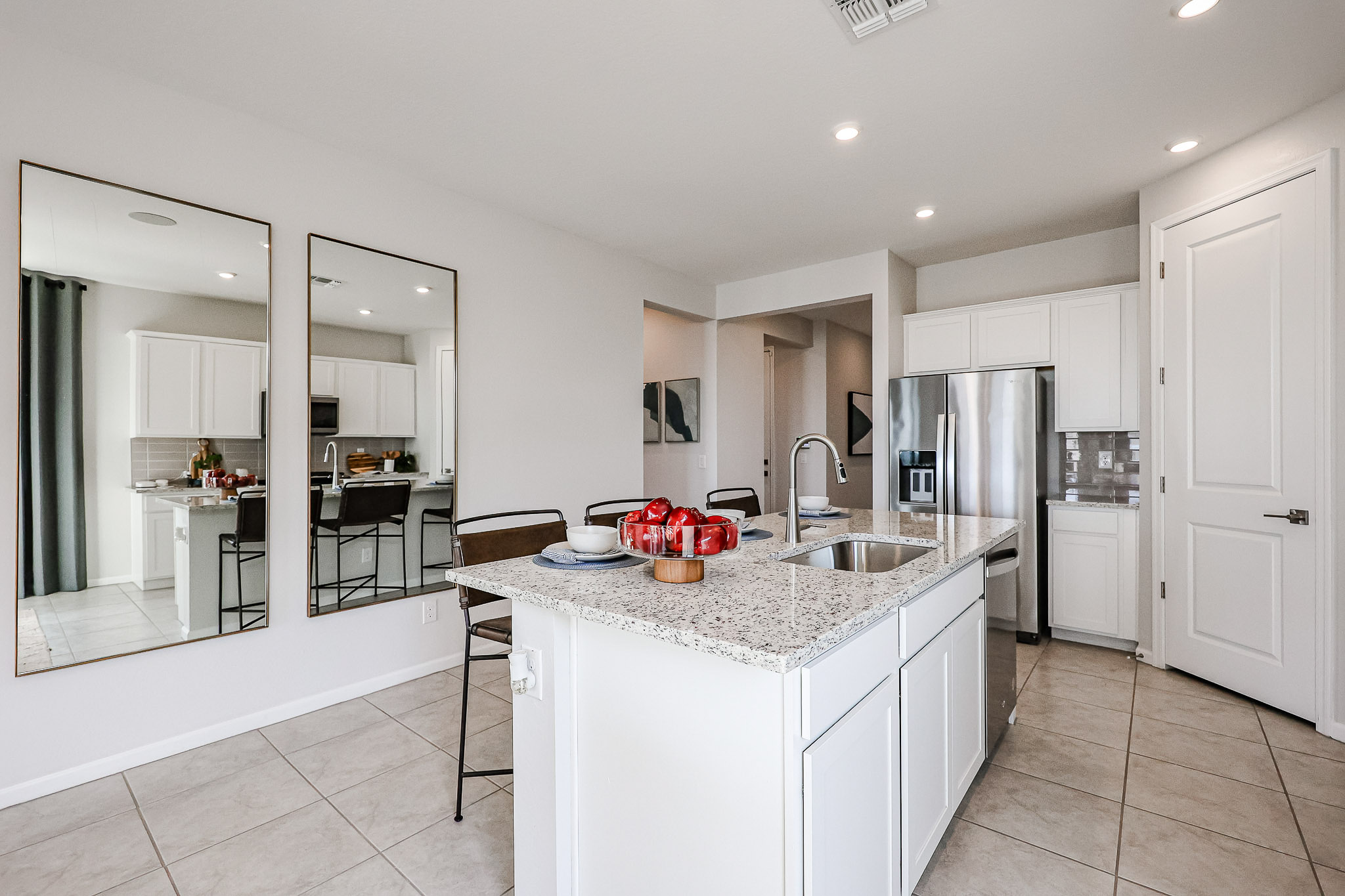 A kitchen with white cabinets.
