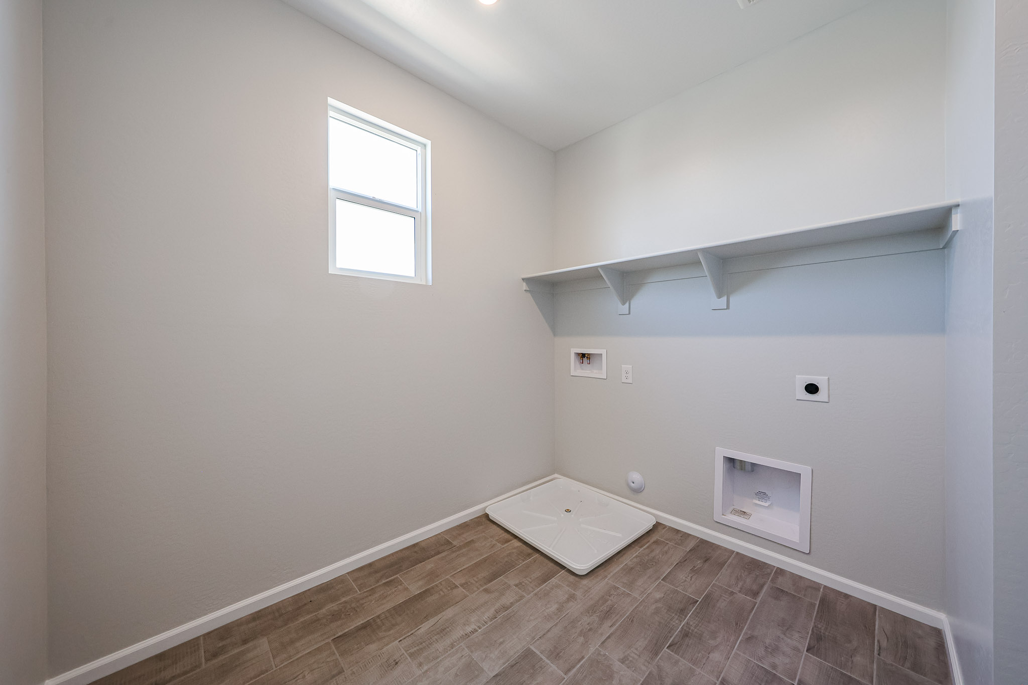 A room with a tile floor and a vent.