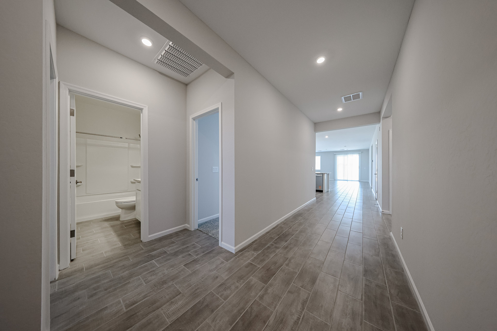 A bathroom with a wood floor.