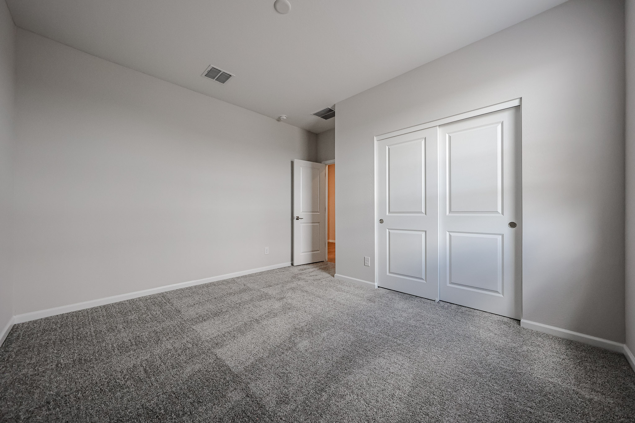 A hallway with white doors.