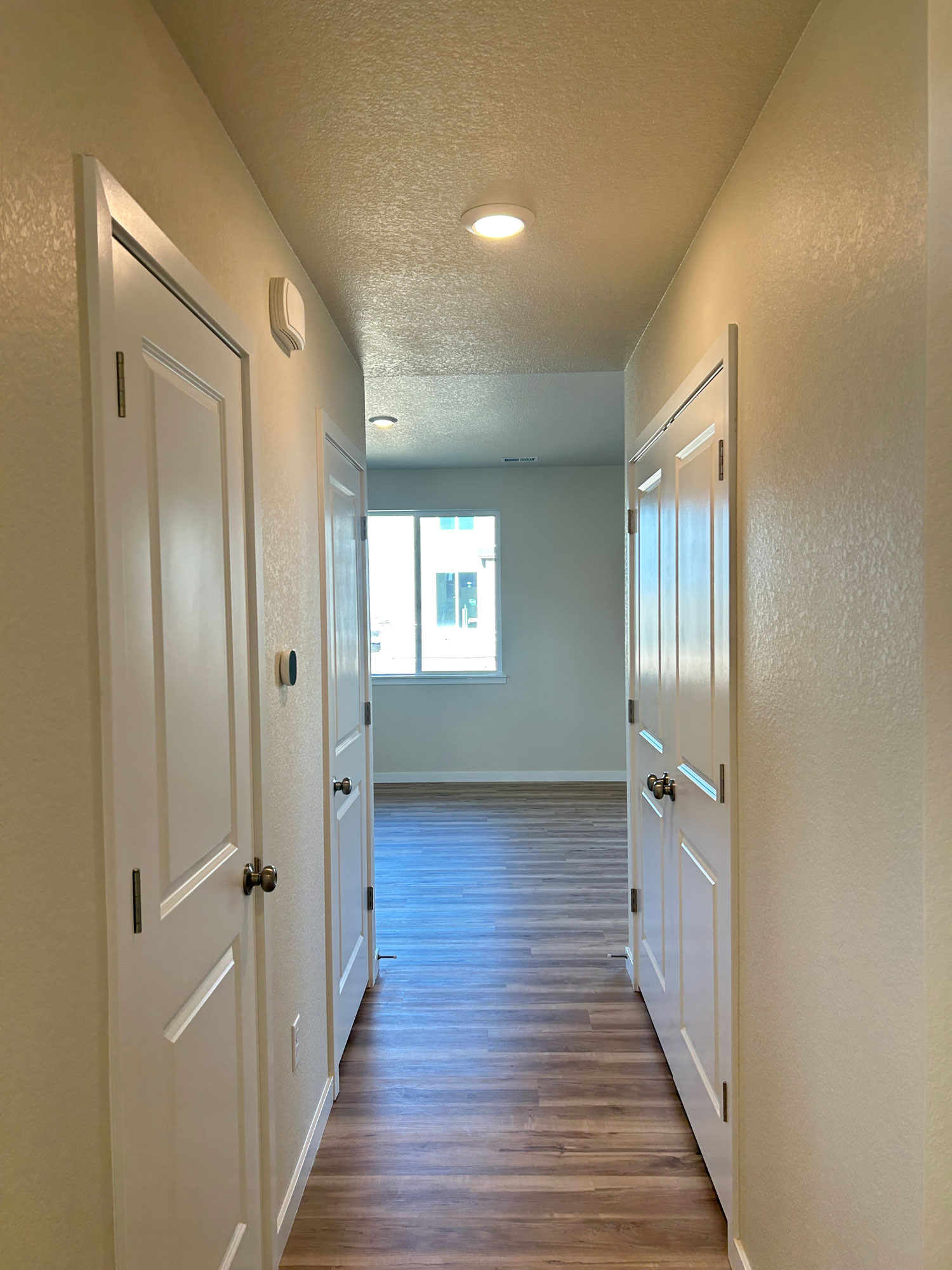 A hallway with white doors.