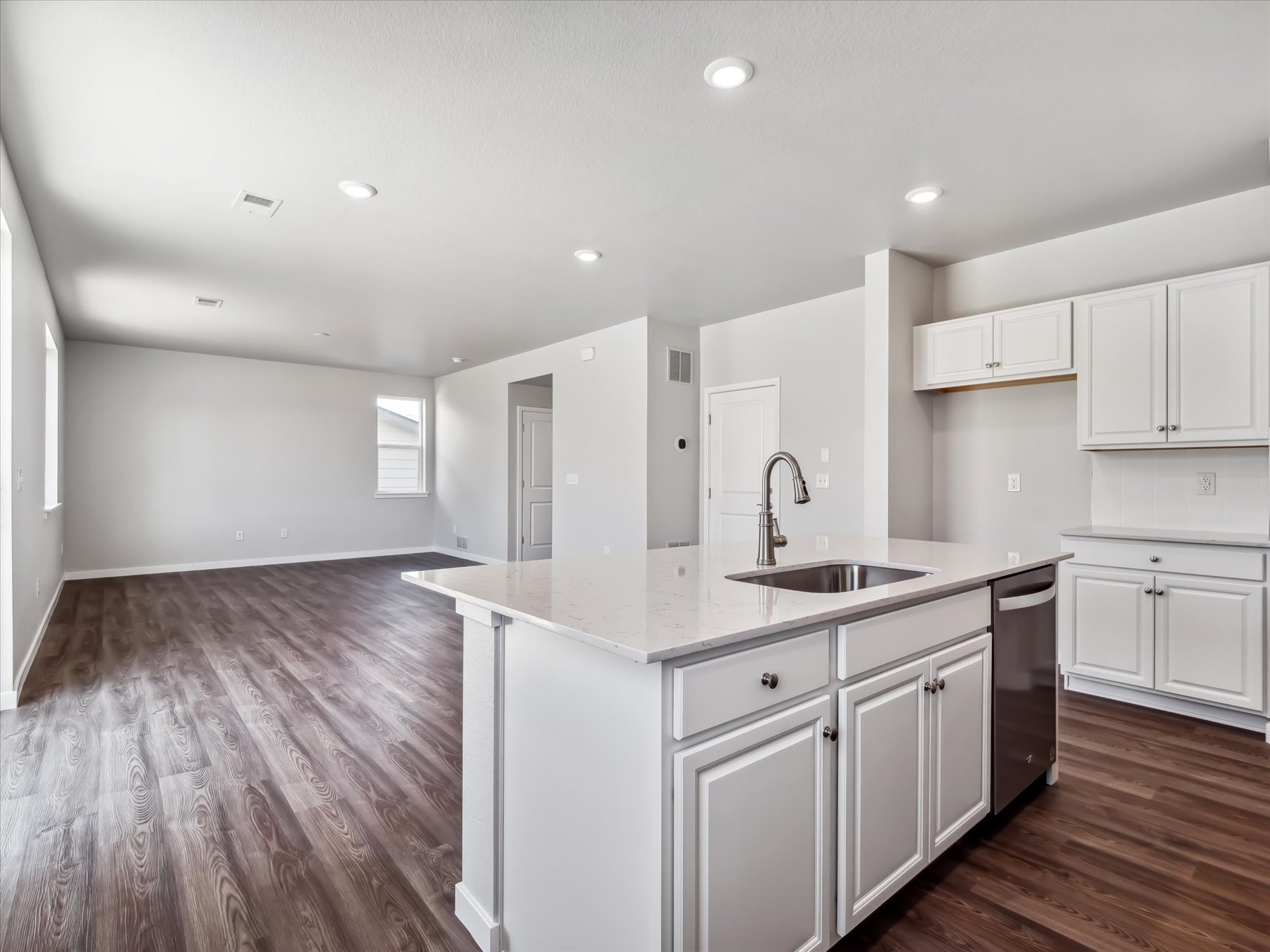 A kitchen with white cabinets.