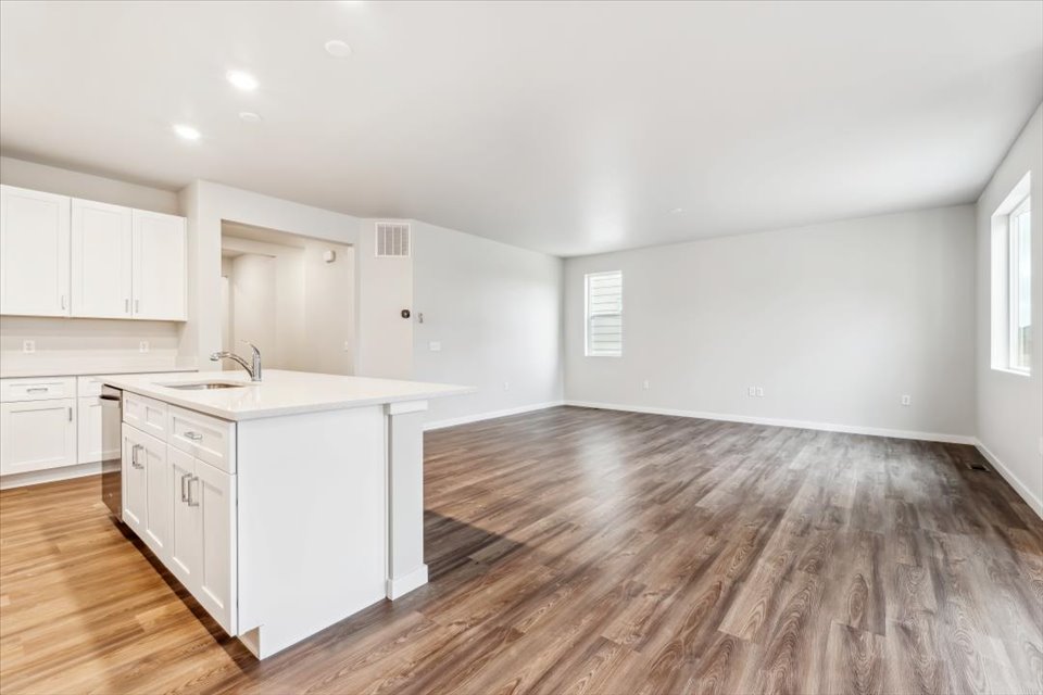 A kitchen with white cabinets.