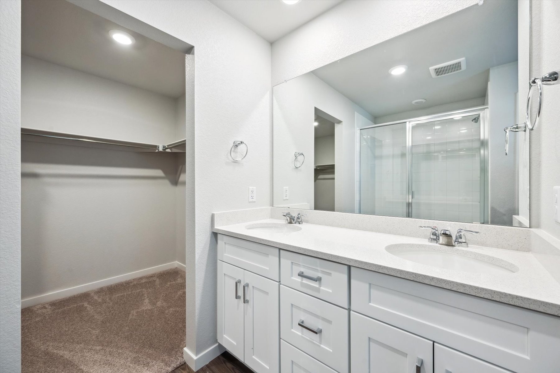 A bathroom with a large mirror.