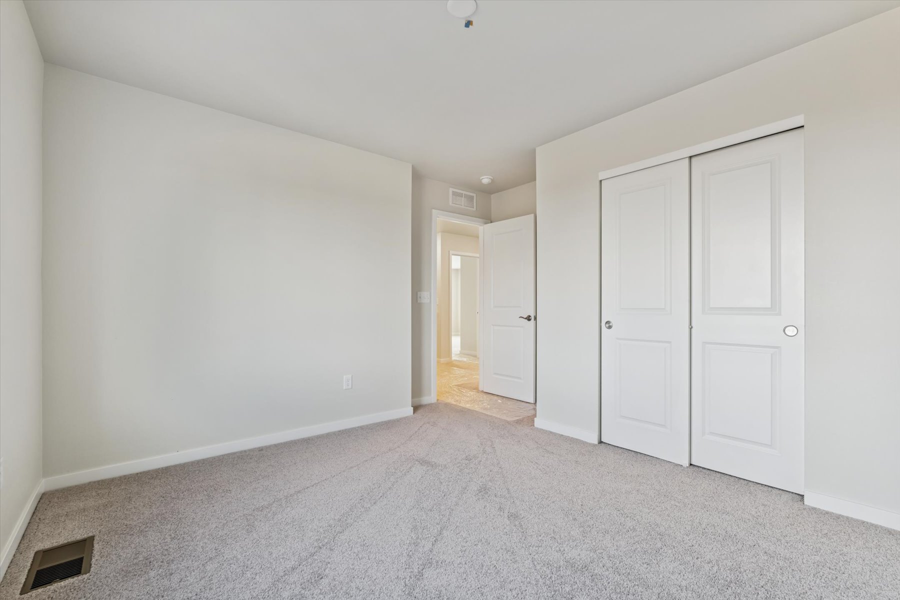 A hallway with white doors.