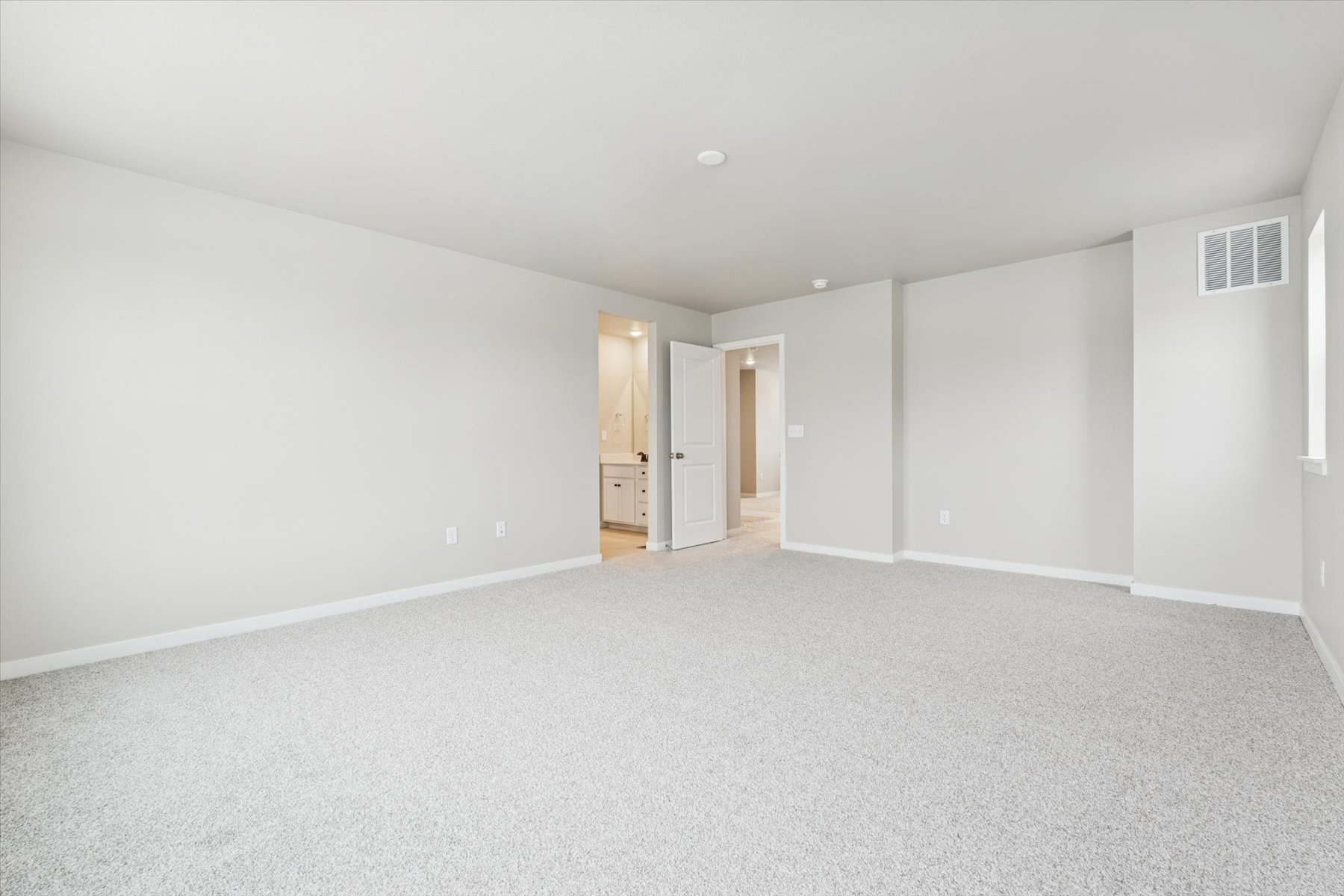 A long hallway with white walls.