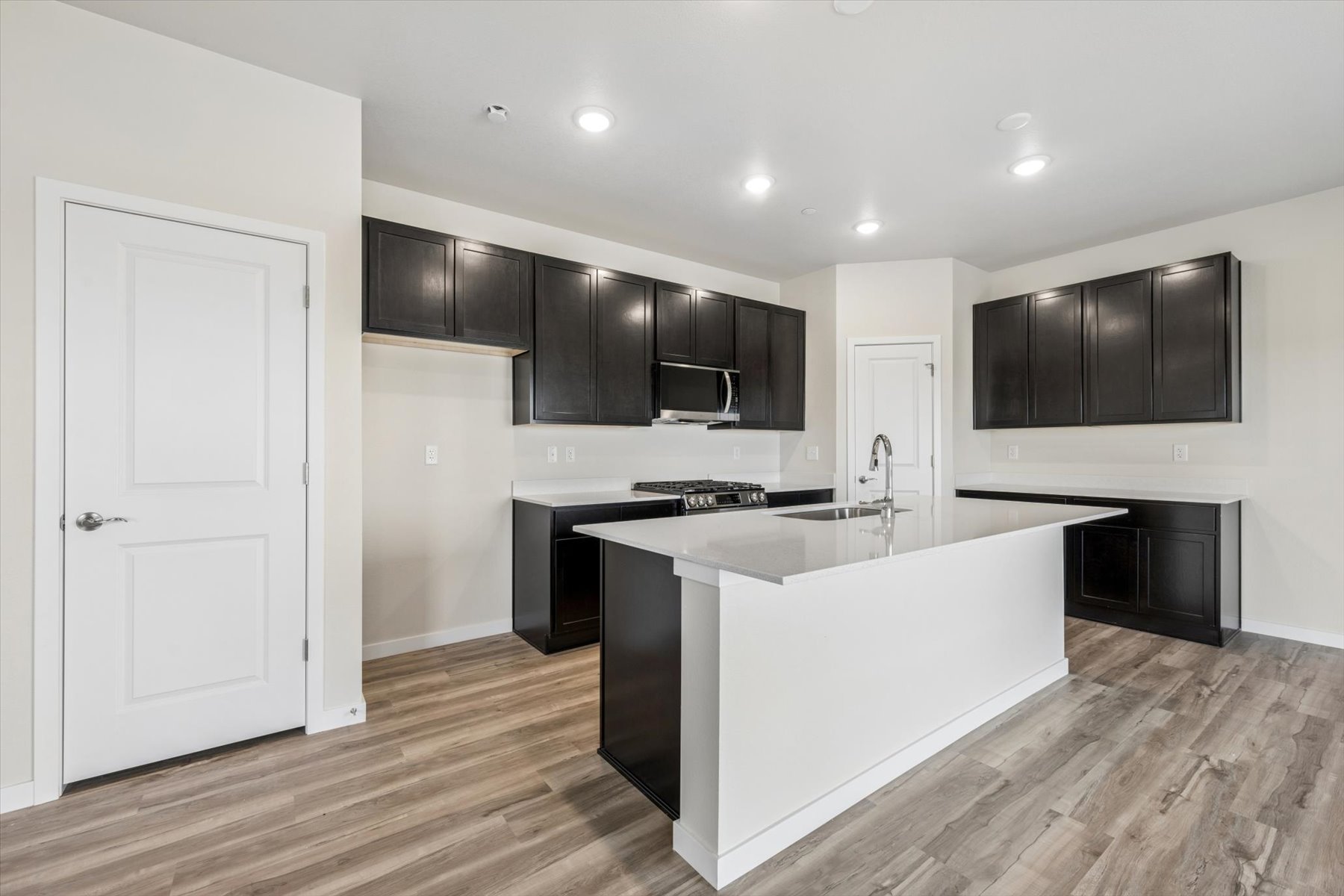 A kitchen with black cabinets.