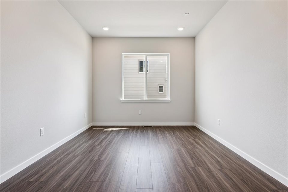 A room with a wood floor and a white door.