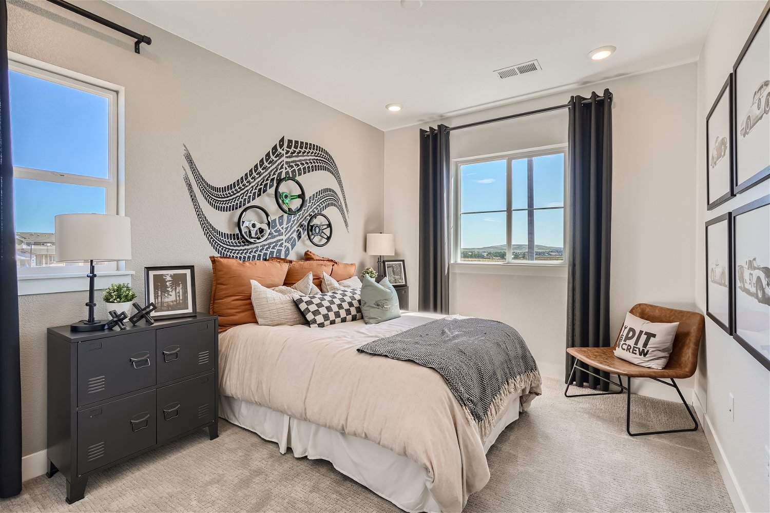 A bedroom with a bed and a chair.