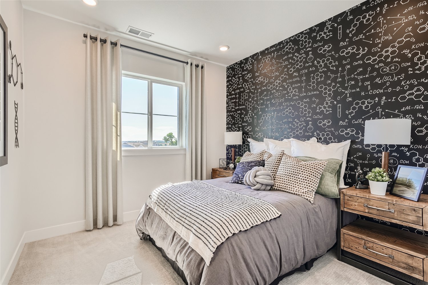 A bedroom with a bed and a window.