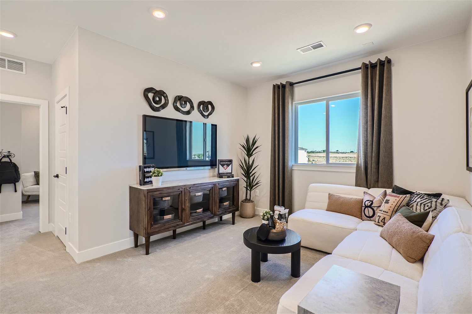 A living room with a tv and couches.