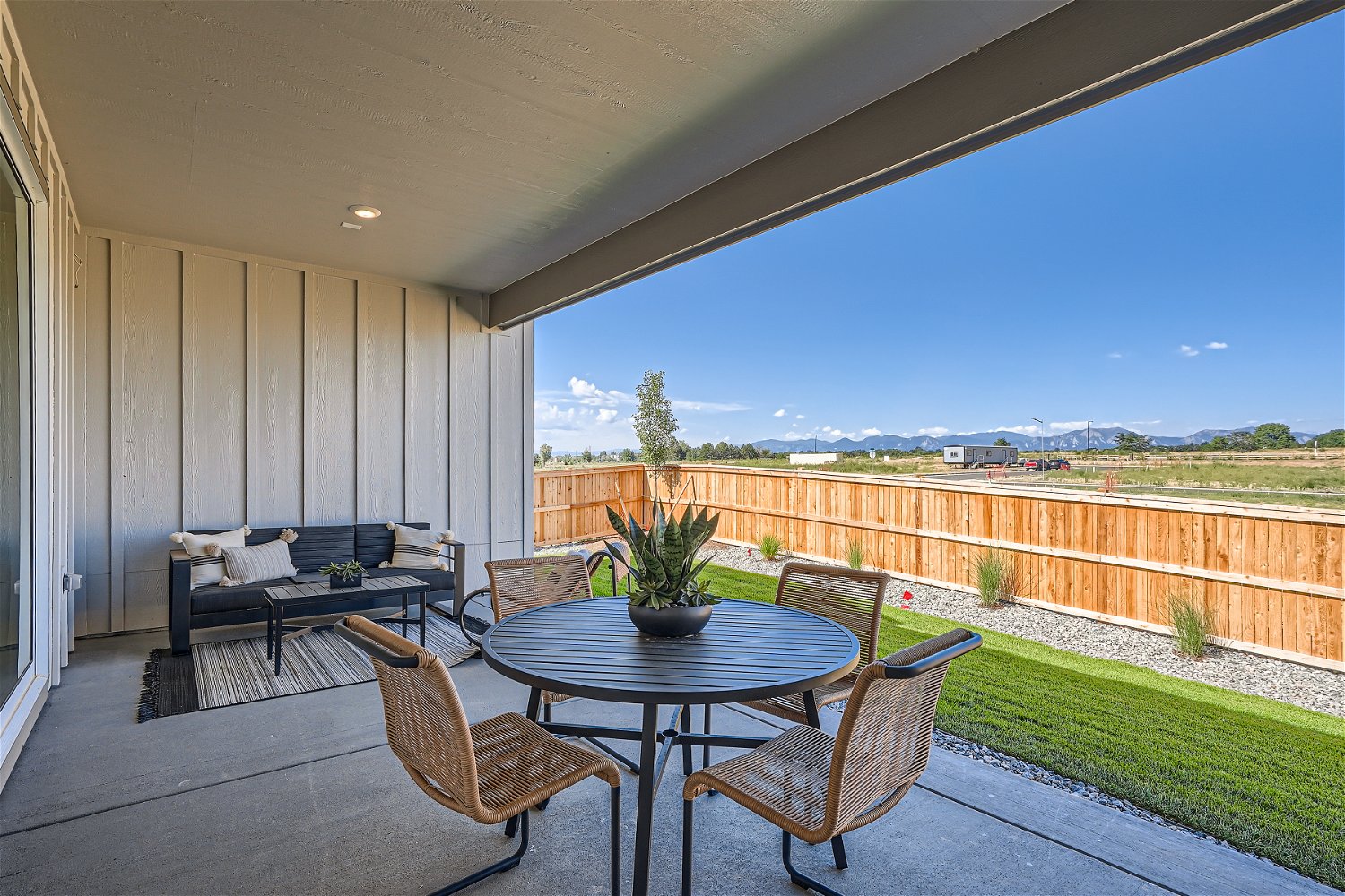 A patio with a table and chairs.