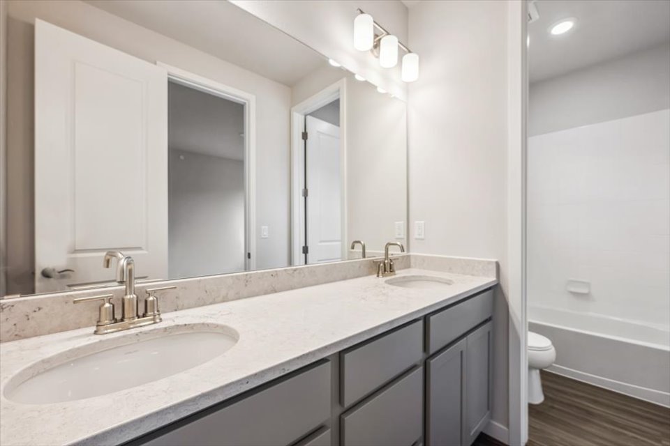 A bathroom with a large mirror.
