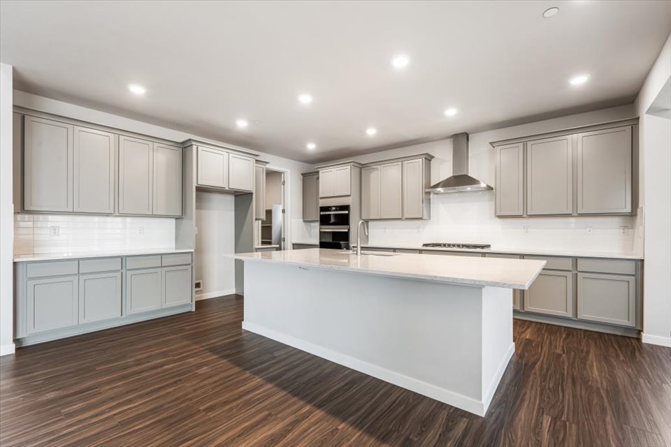 A kitchen with white cabinets.