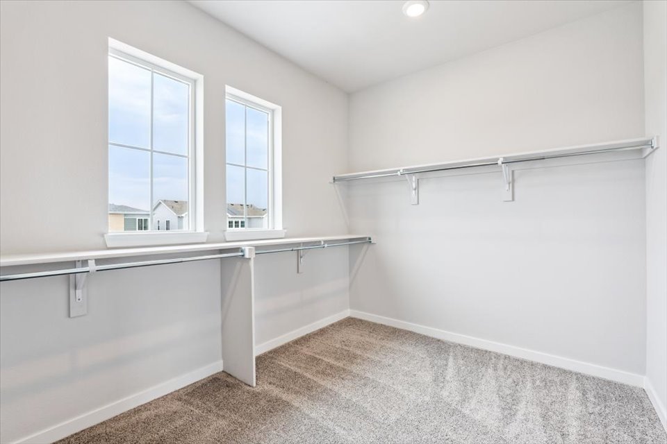 A white room with a window and a white wall.