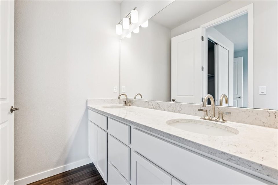A bathroom with a large mirror.