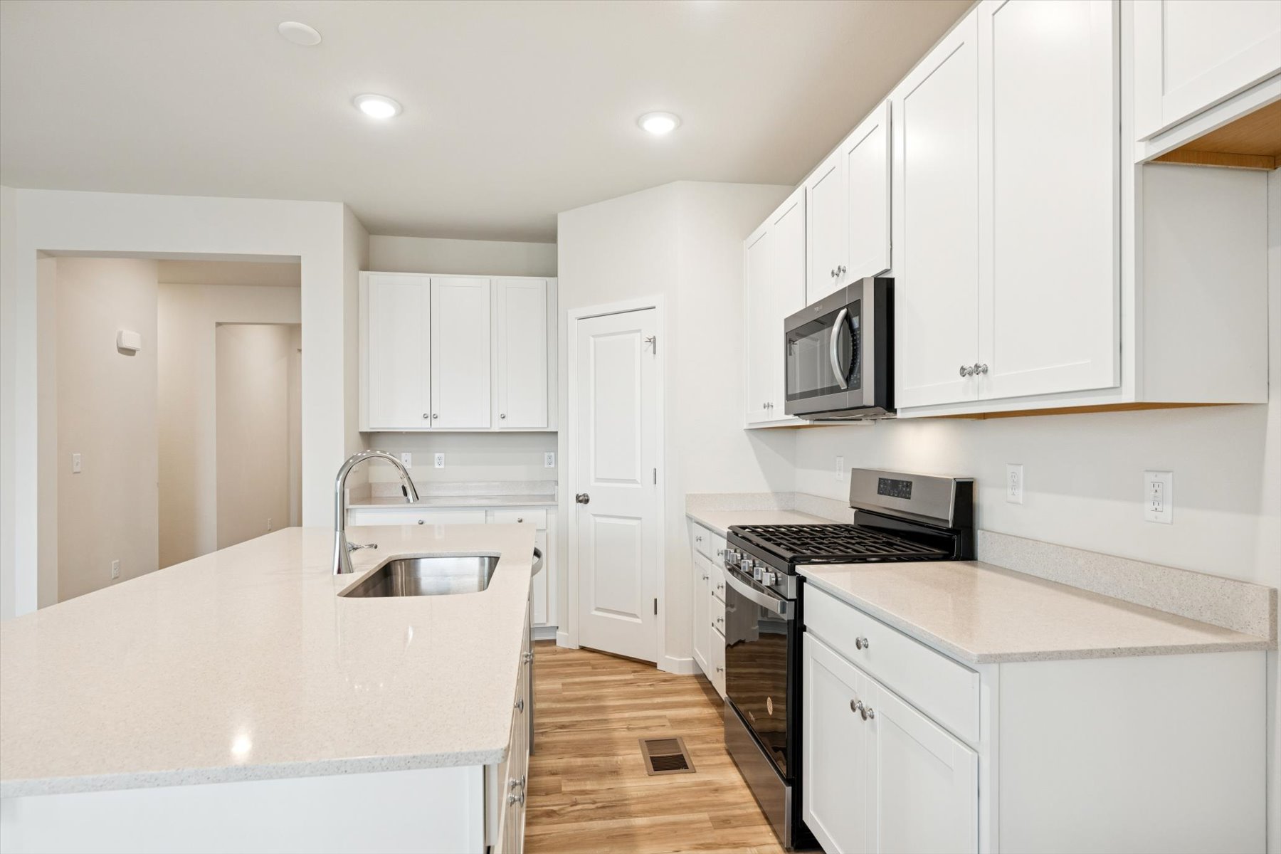 A kitchen with white cabinets.