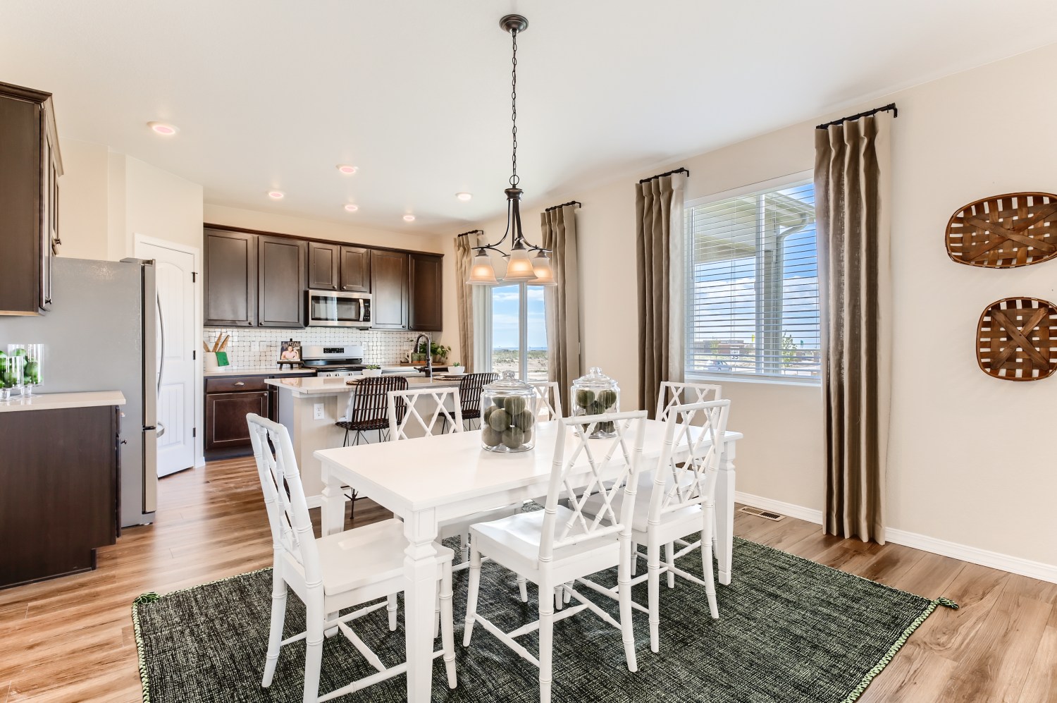A kitchen with a dining table and chairs.