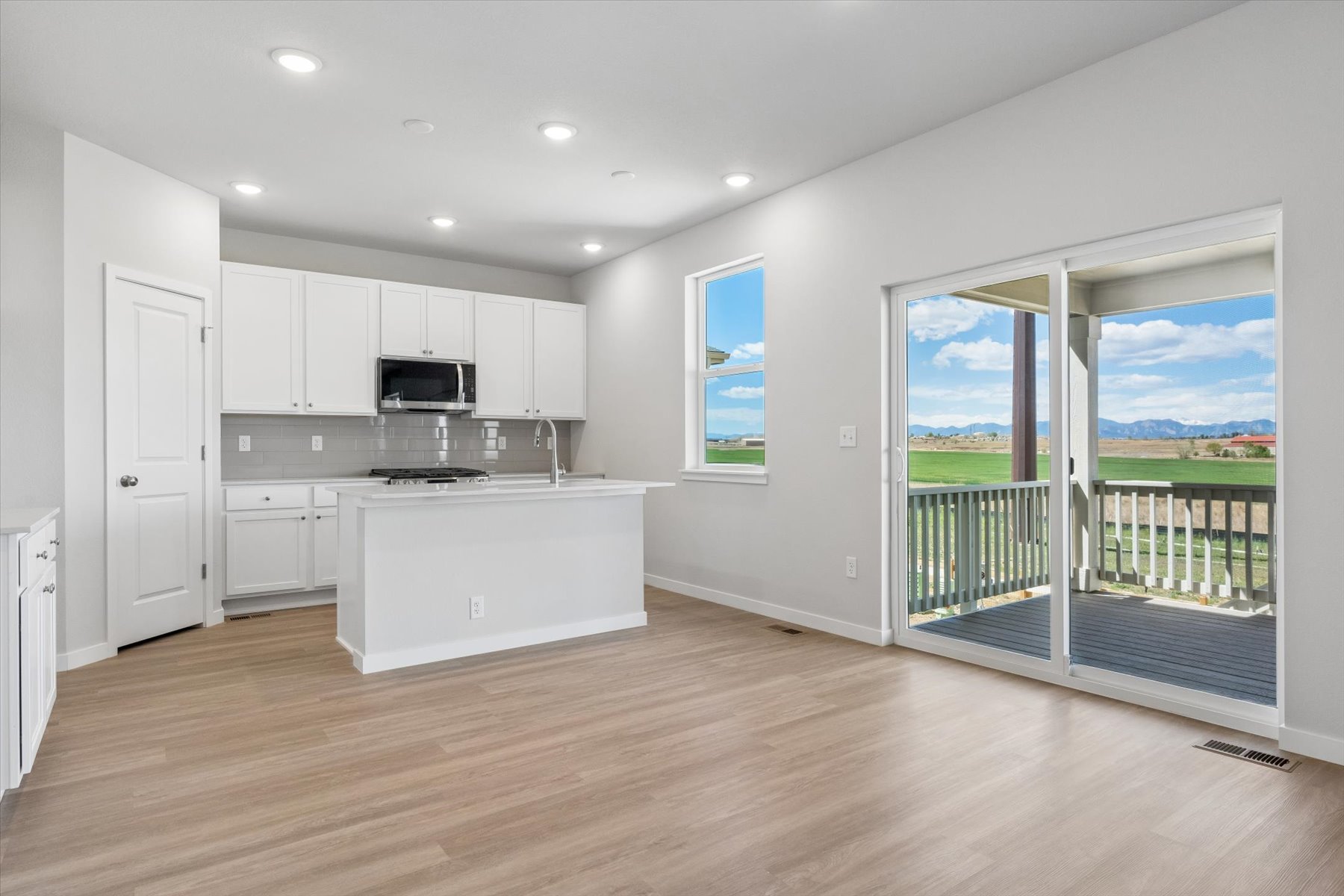 A kitchen with white cabinets.