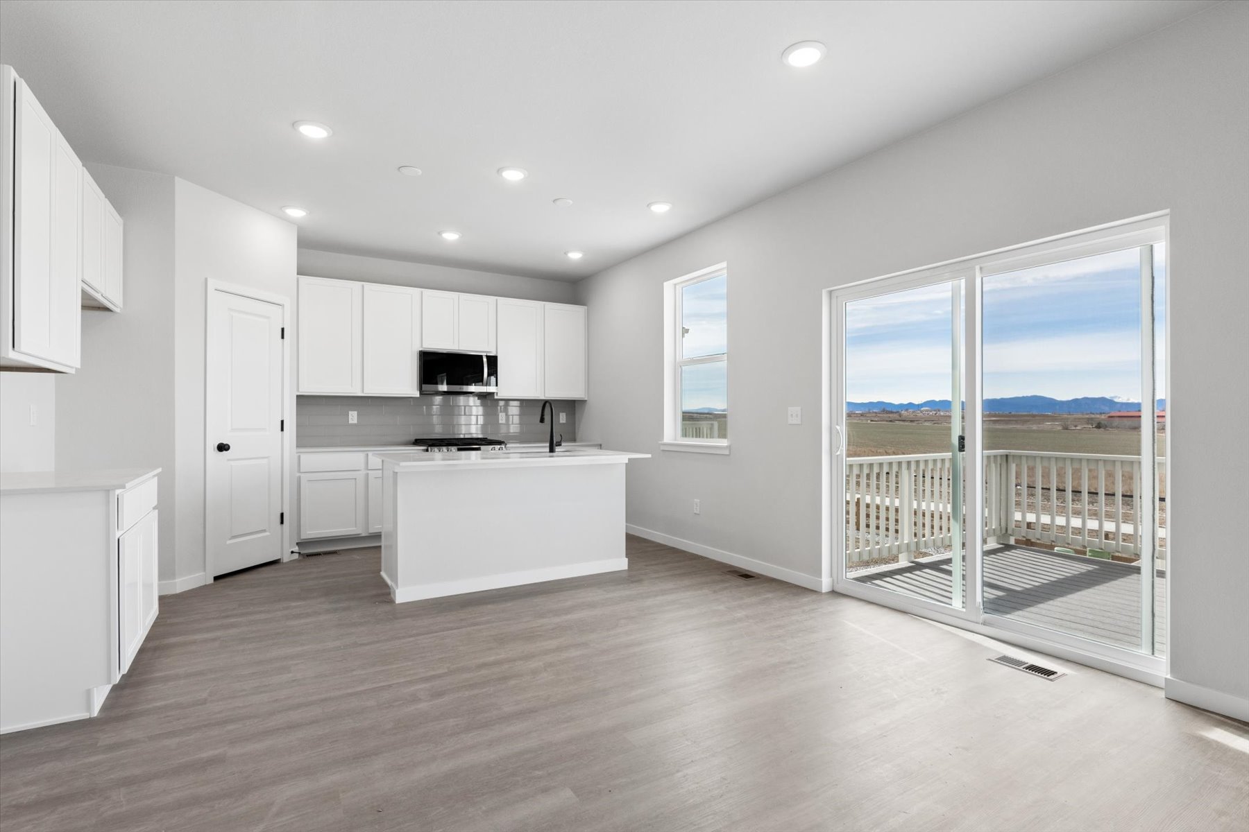 A kitchen with a large glass door.