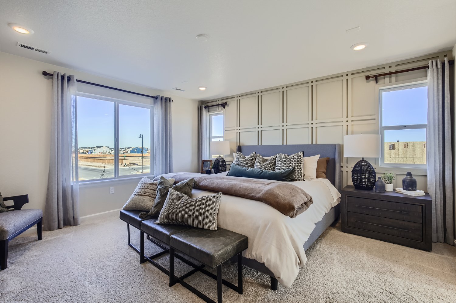 A bedroom with a large window.
