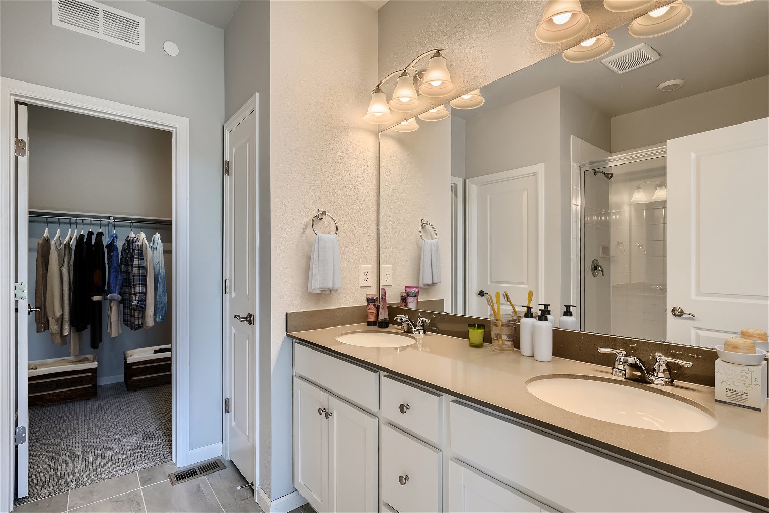 A bathroom with a large mirror.