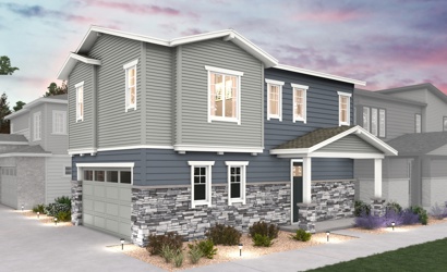 A grey house with a driveway.