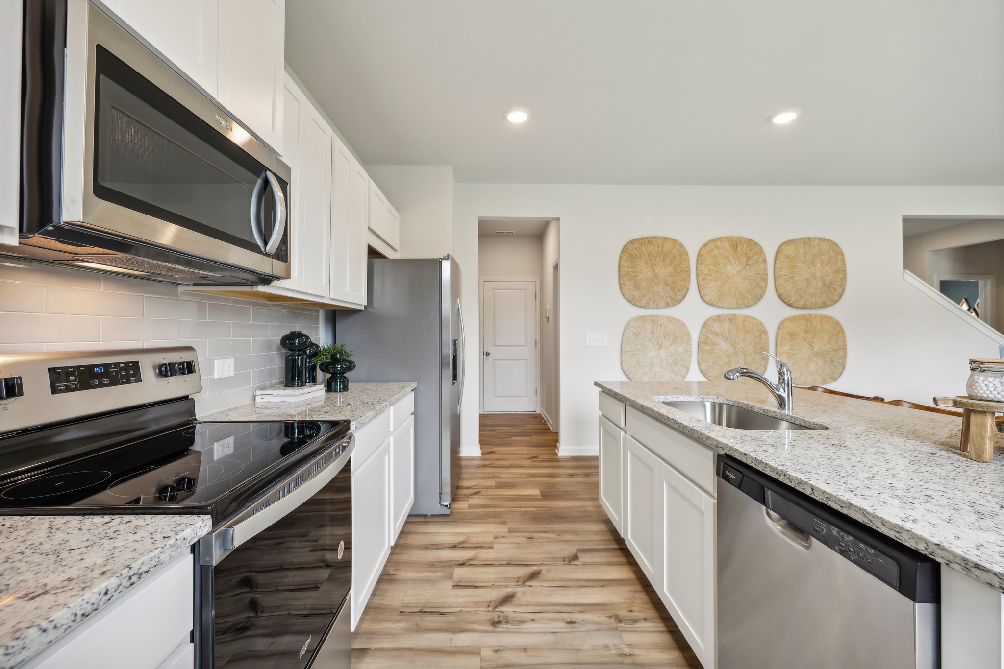 A kitchen with white cabinets.