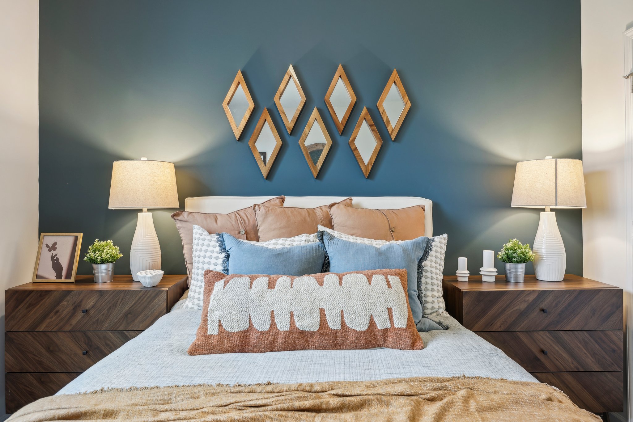 A bed with a blue wall.