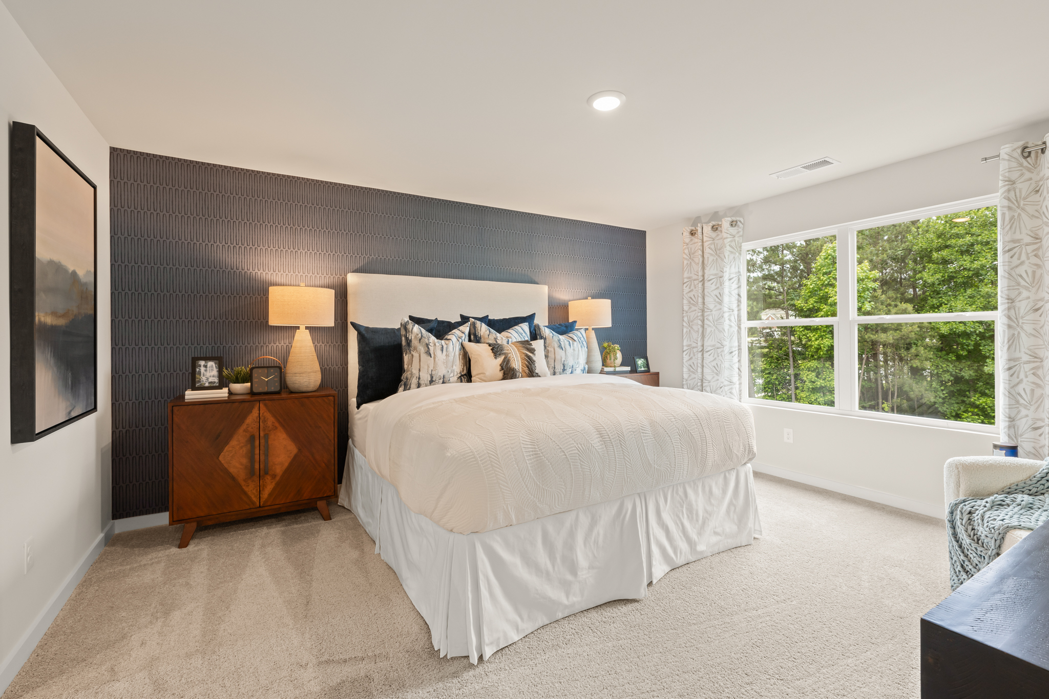 A bedroom with a bed and a window.