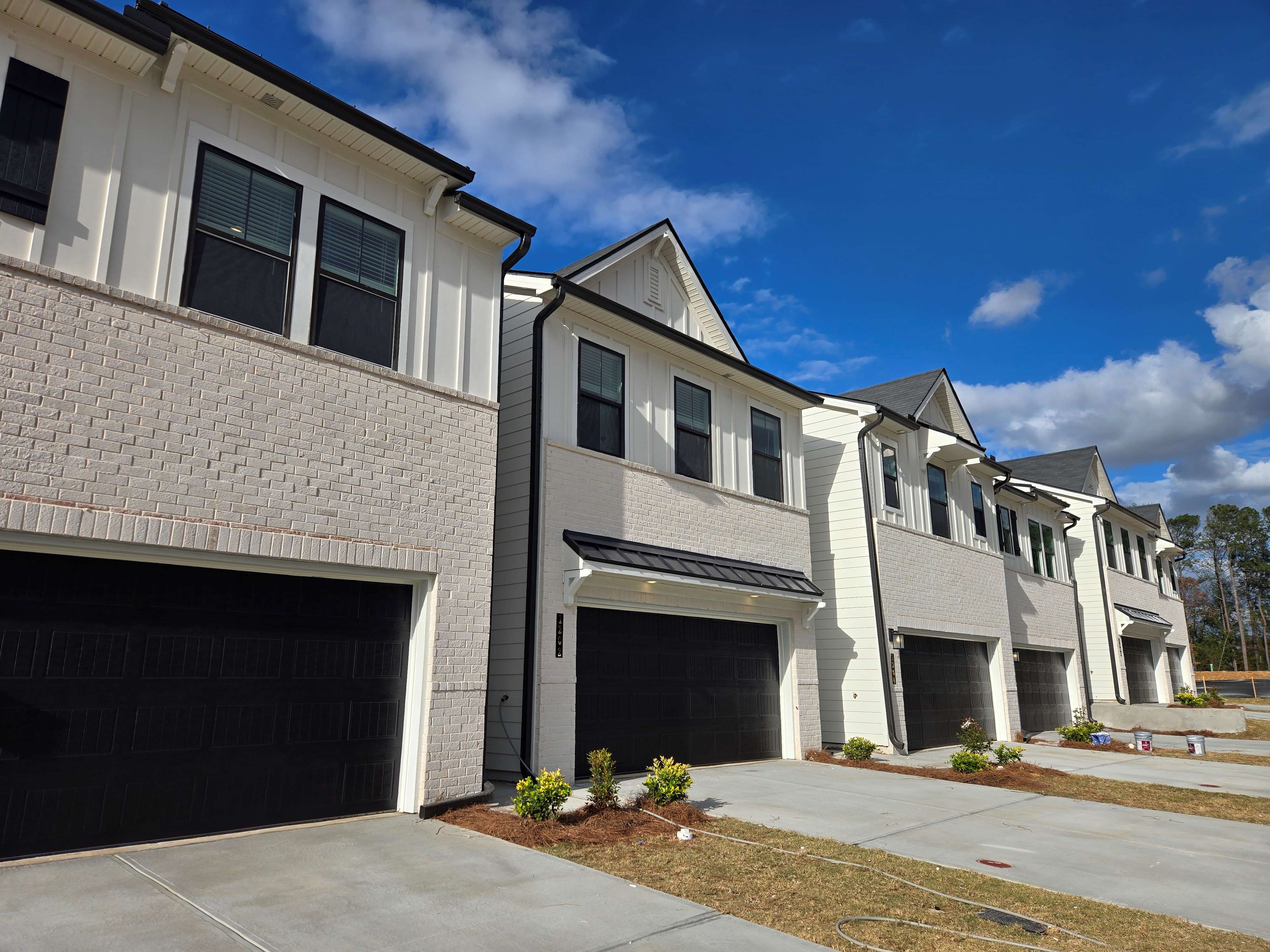 A white building with a garage.