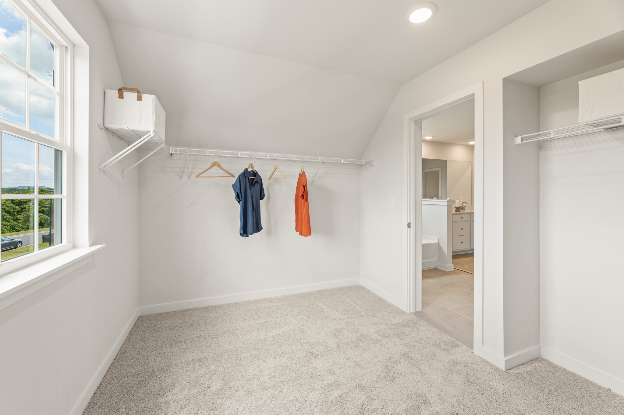 A white room with a white wall and a window.